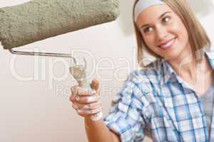 Home improvement: Young woman with paint roller