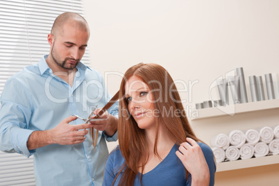 Professional hairdresser cut with scissors at salon