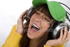 Happy female teenager enjoy music with headphones