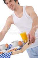 Breakfast - young man holding tray toast and juice