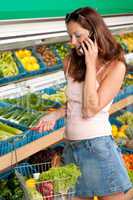 Grocery store shopping -  Woman holding mobile phone