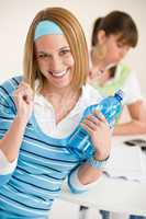Student at home - smiling woman with bottle of water