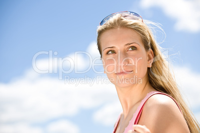 Portrait of blond woman with summer sky