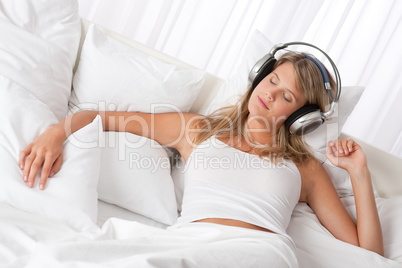 White lounge - Blond woman with headphones listening to music