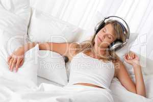 White lounge - Blond woman with headphones listening to music