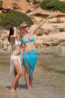 Two attractive woman in bikini on the beach