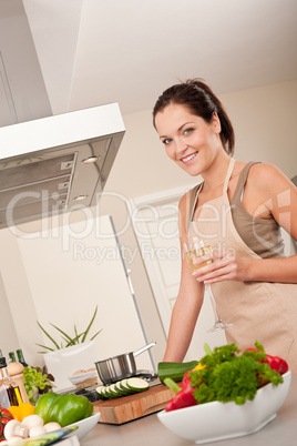 Smiling young woman cooking in the kitchen