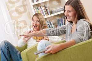 Students - Two smiling female teenager watching television