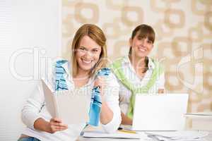 Student at home - two woman with book and laptop