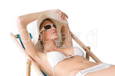 Beach - woman in bikini with hat sunbathing