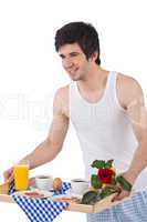 Breakfast - young man holding tray with rose