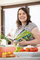Cook - Plus size happy woman holding cookbook