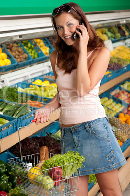 Grocery store shopping - Smiling woman with mobile phone