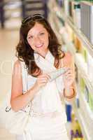 Shopping cosmetics - smiling woman with moisturizer