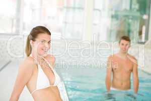 Swimming pool - young sportive couple relax