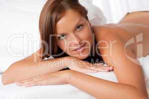 White lounge - Naked woman lying on white bed