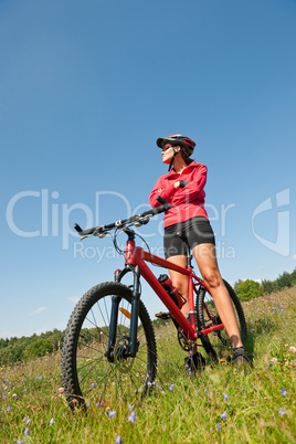 Young woman with mountain bike in spring nature