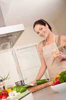 Smiling young woman cooking in the kitchen