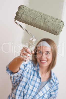 Home improvement: Smiling woman with paint roller