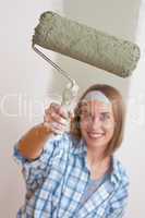 Home improvement: Smiling woman with paint roller