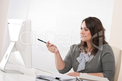 Young business woman working with computer at office