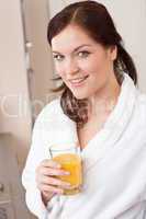 Young woman drink orange juice for breakfast in kitchen