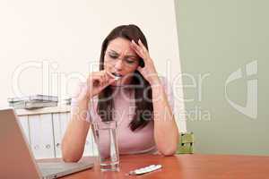 Businesswoman with headache take pill