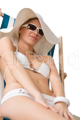 Beach - woman in bikini with hat sunbathing