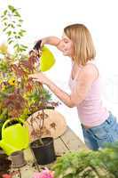 Gardening - woman sprinkling water to plant