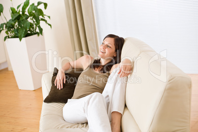 Young woman relax lying down on sofa