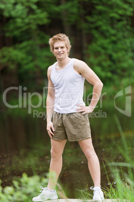 Sportive man stretching after training in nature