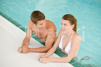 Swimming pool - young cheerful couple have fun