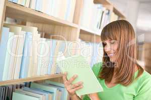 Student in library - happy woman read book