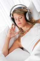 White lounge - Blond woman with headphones listening to music