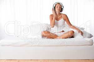 Young woman in white with headphones