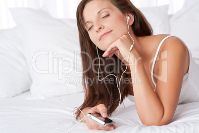 Young woman listening to music holding mp3 player