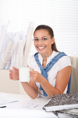 Happy female architect with coffee
