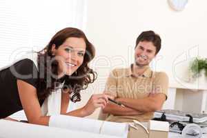 Smiling man and woman with architectural model