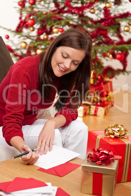 Attractive brunette writing Christmas cards