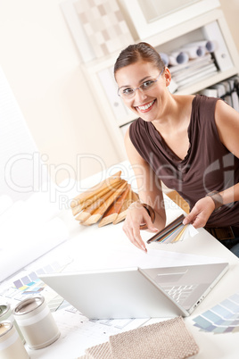 Smiling female designer with color swatch