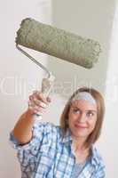 Home improvement: Smiling woman with paint roller