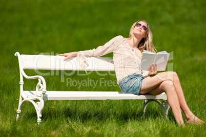 Spring and summer - Young woman relaxing in meadow