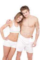 Fitness - Young sportive smiling couple on white