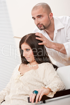 Professional hairdresser comb female customer at salon