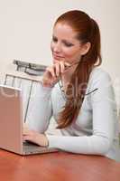 Long red hair woman at office holding glasses