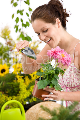 Gardening - woman holding flower pot and shovel