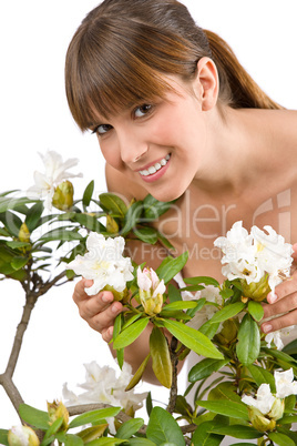 Gardening - Portrait of woman with Rhododendron flower