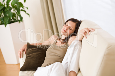 Beautiful woman lying down sleeping on sofa