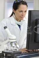 Female Scientist or Doctor Using Computer In Laboratory