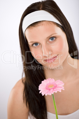 Beautiful woman holding gerbera daisy flower